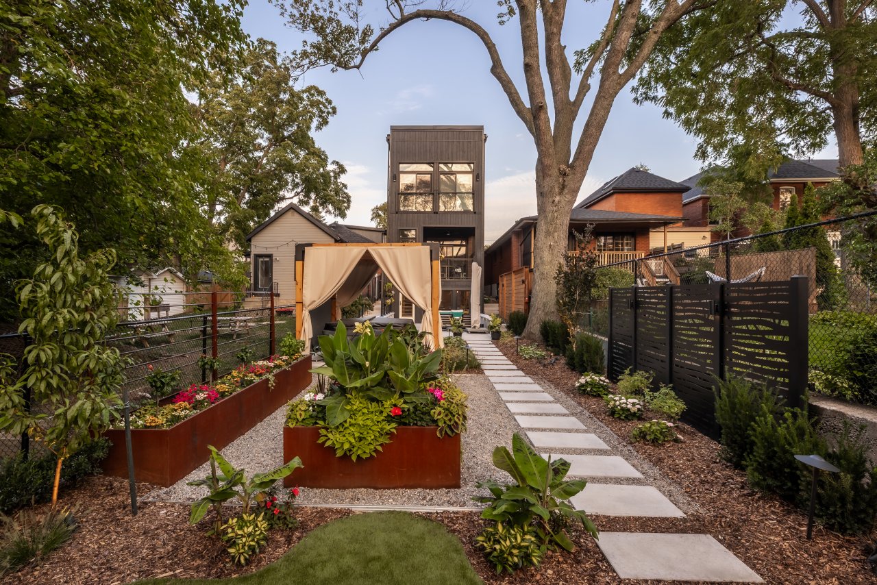 Professionally designed Ontario backyard with raised planter beds, privacy screening, and integrated pathways